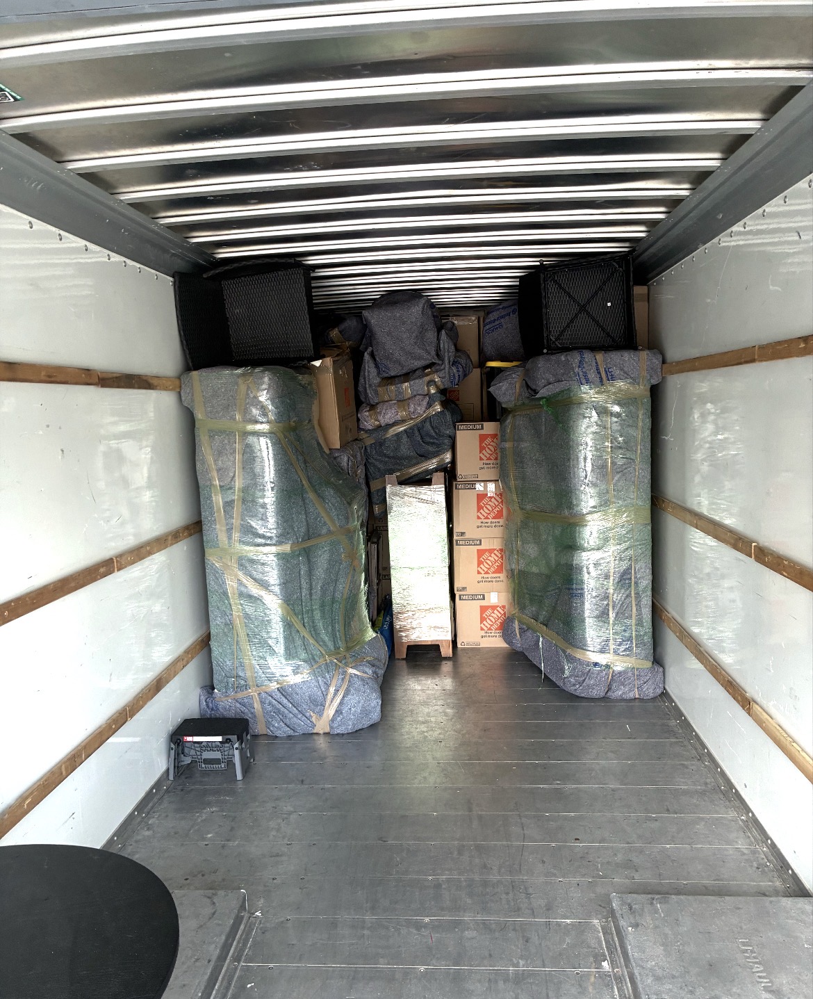 Furniture protected with blankets and secured inside a Mountain Movers project truck